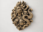 Right angle of the siren sculpture showing face and shell detail