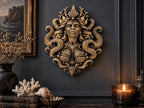 Siren Queen sculpture on a dark wall above coral, shells and a candle