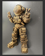 Right angle of the gold astronaut showing helmet and suit depth