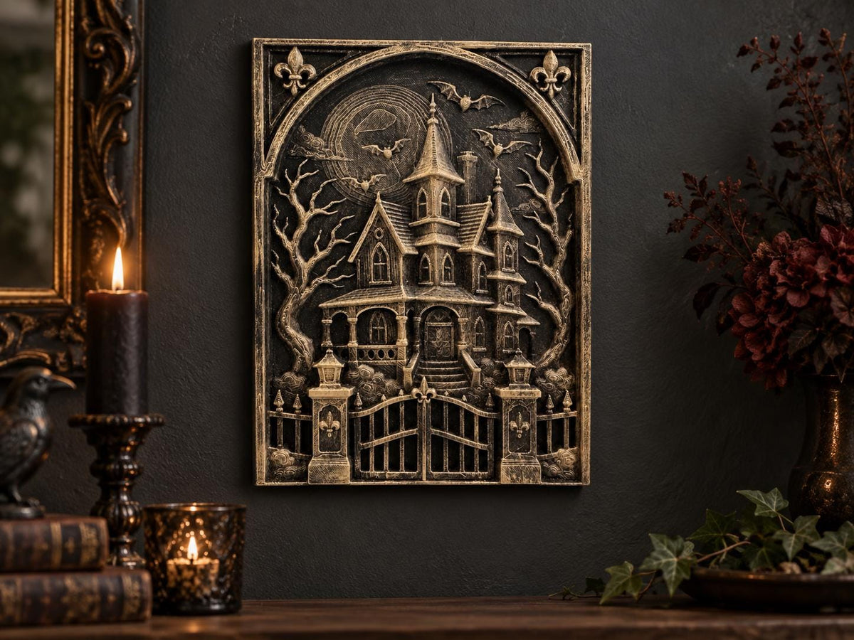 Haunted house sculpture on a dark wall beside a candle and books
