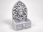 Front view of the Medusa organizer showing serpent hair and arched frame