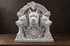Front view of gray-white Cerberus sculpture with three dog heads in a ruined Greek arch
