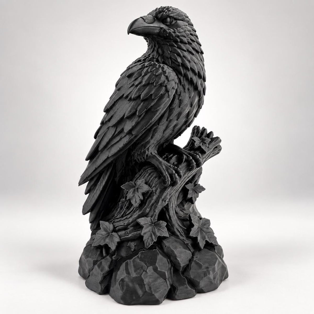 Front angle of the black raven statue showing layered feathers and beak