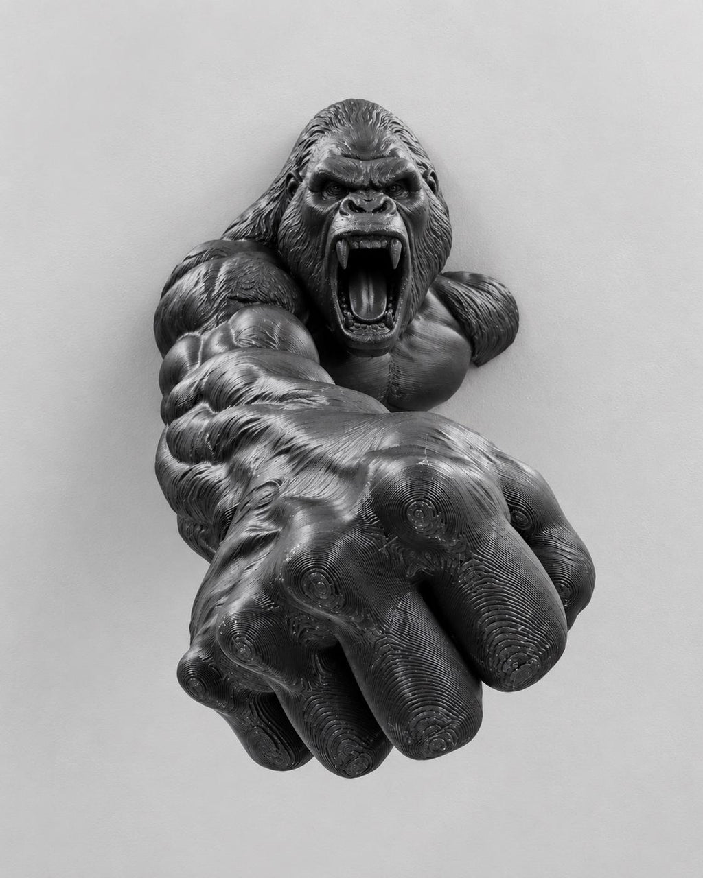 Front view of black roaring gorilla wall sculpture reaching out with a huge fist