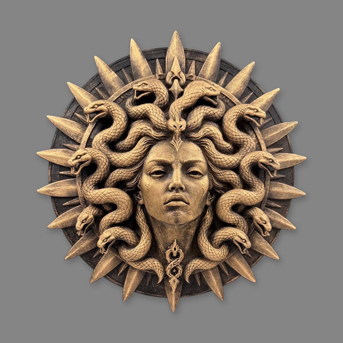Front view of antique gold Medusa sunburst medallion with coiled serpents and spikes