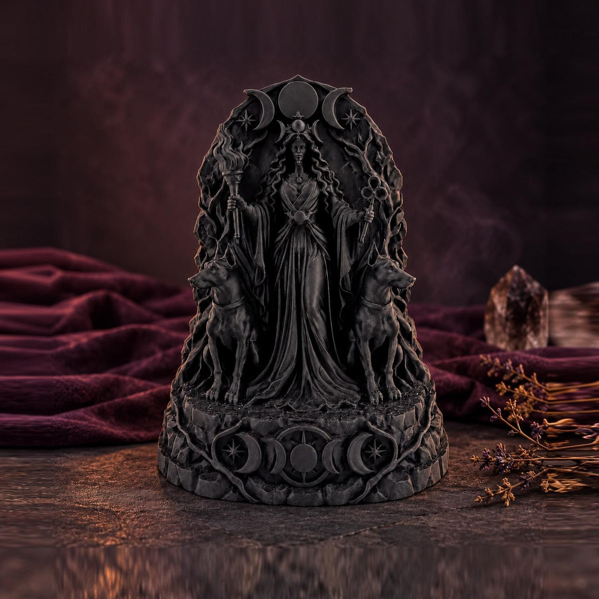 Front view of black Hecate statue with hounds on a dark red backdrop