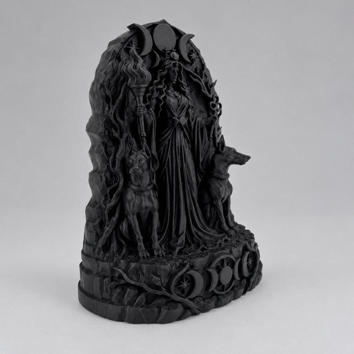 Side angle of the black Hecate statue showing hound and branch detail