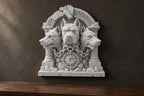 Slight angle of the three-headed dog relief showing chains and sun medallion