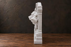 Side profile of the Cerberus sculpture showing its relief depth