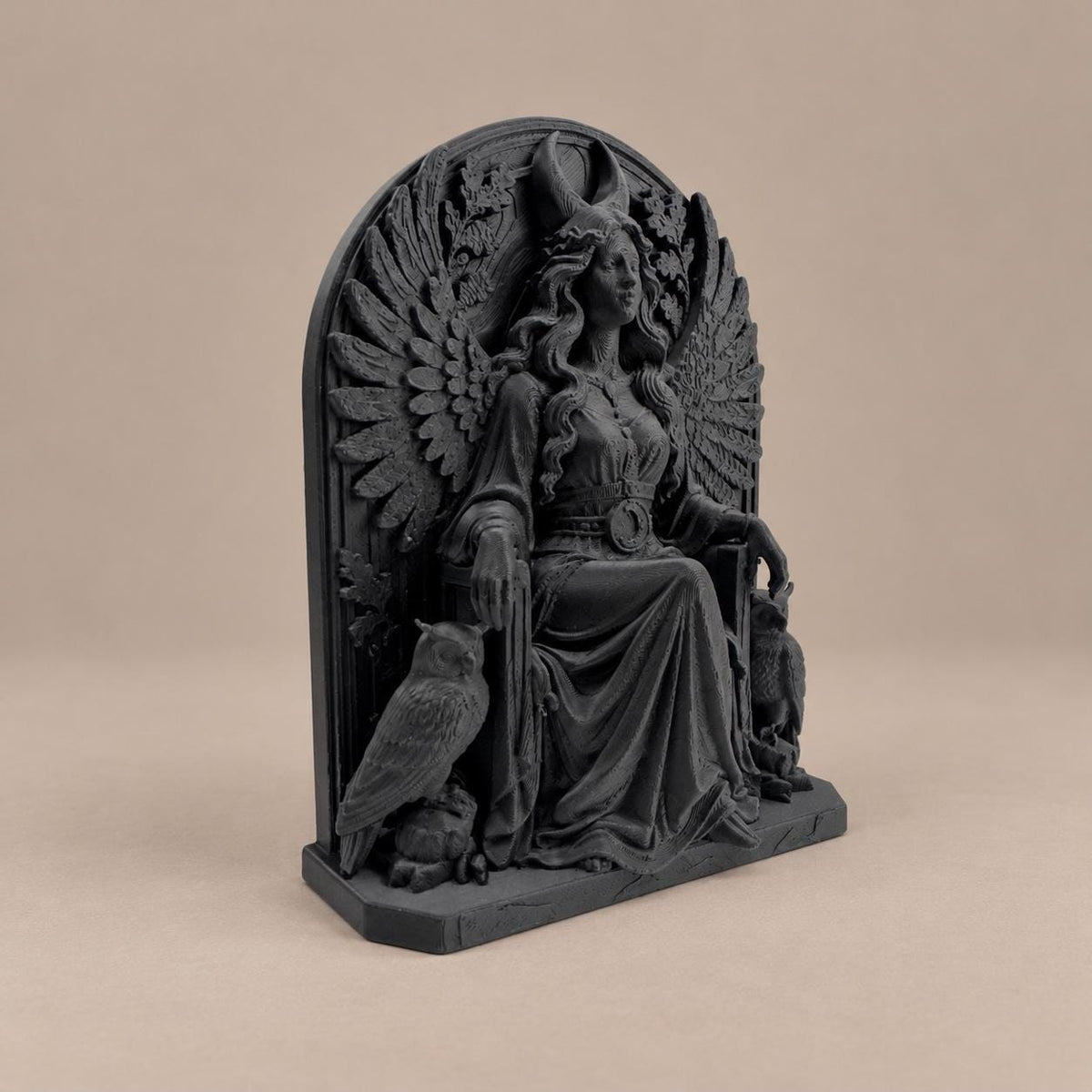 Left angle of the Lilith statue showing feathered wings and owl