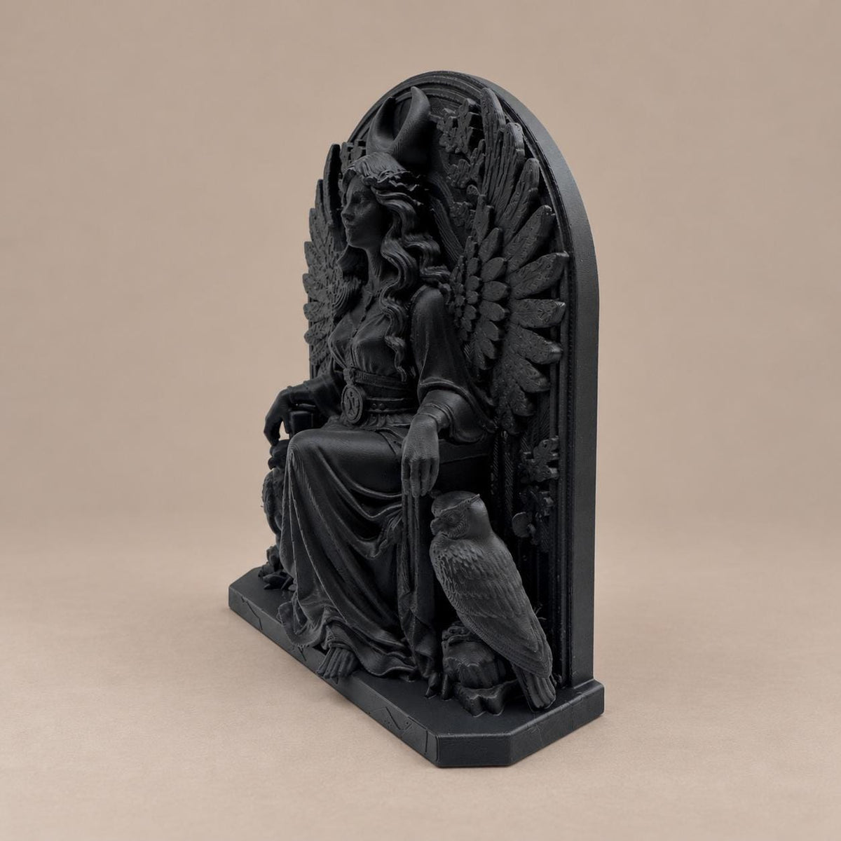 Right angle of the seated winged goddess statue showing depth