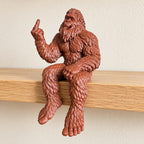 Middle finger Bigfoot figurine displayed as man cave decor